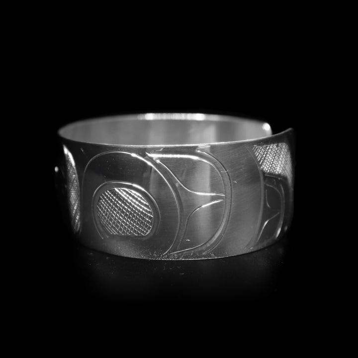 This sterling silver wide cuff bracelet has a full depiction of the Orca beautifully carved into the surface of the band.