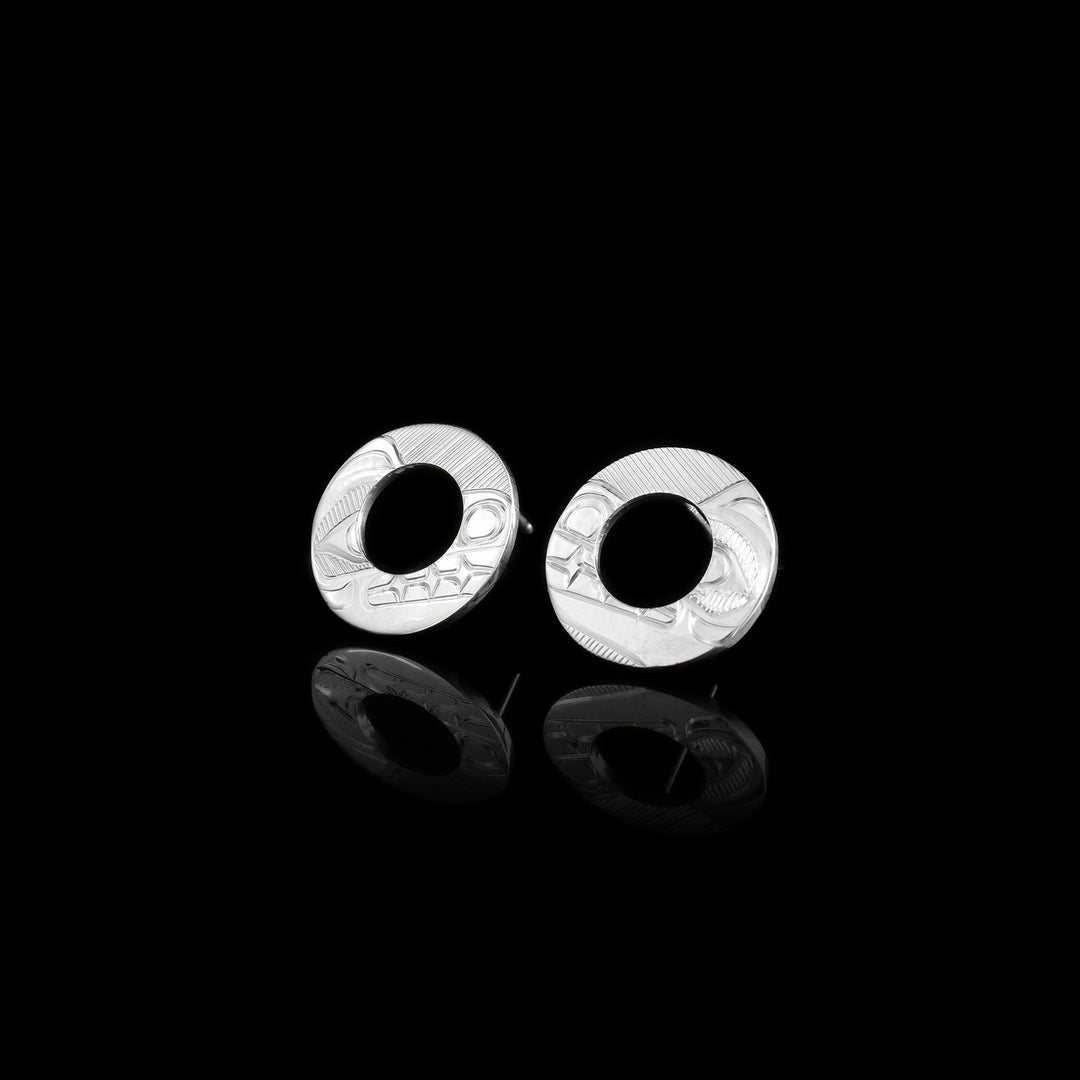 These Bear earrings studs are made from sterling silver and are circle shaped. There is a circle cutout in the center and carvings on the surface of them depicting the head of the Bear.