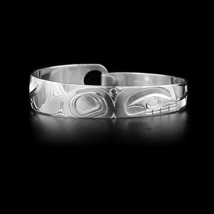 This sterling silver, tapered Orca bracelet has a depiction of the Orca carved into it.