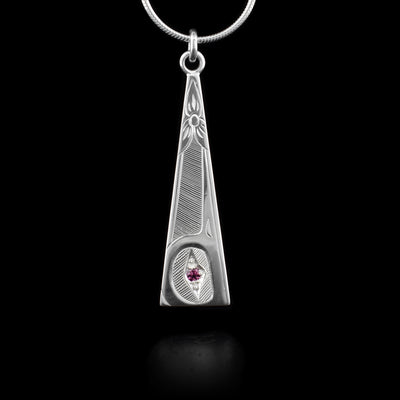 This sterling silver Hummingbird pendant is a long, thin triangle with a depiction of the Hummingbird carved into it. There is a tourmaline gem in the eye of the Hummingbird.