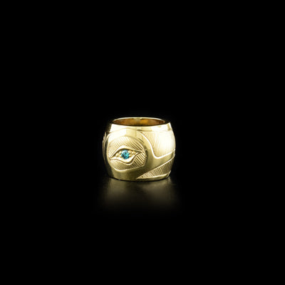 This spirit bead is made from 14K gold and has a depiction of the Hummingbird carved into it. There is an blue diamond embedded in the eye of the Hummingbird.