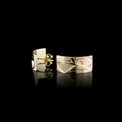 These 14K gold half hoop earrings are wide and have depictions of the head of the Eagle carved into the surface of them.