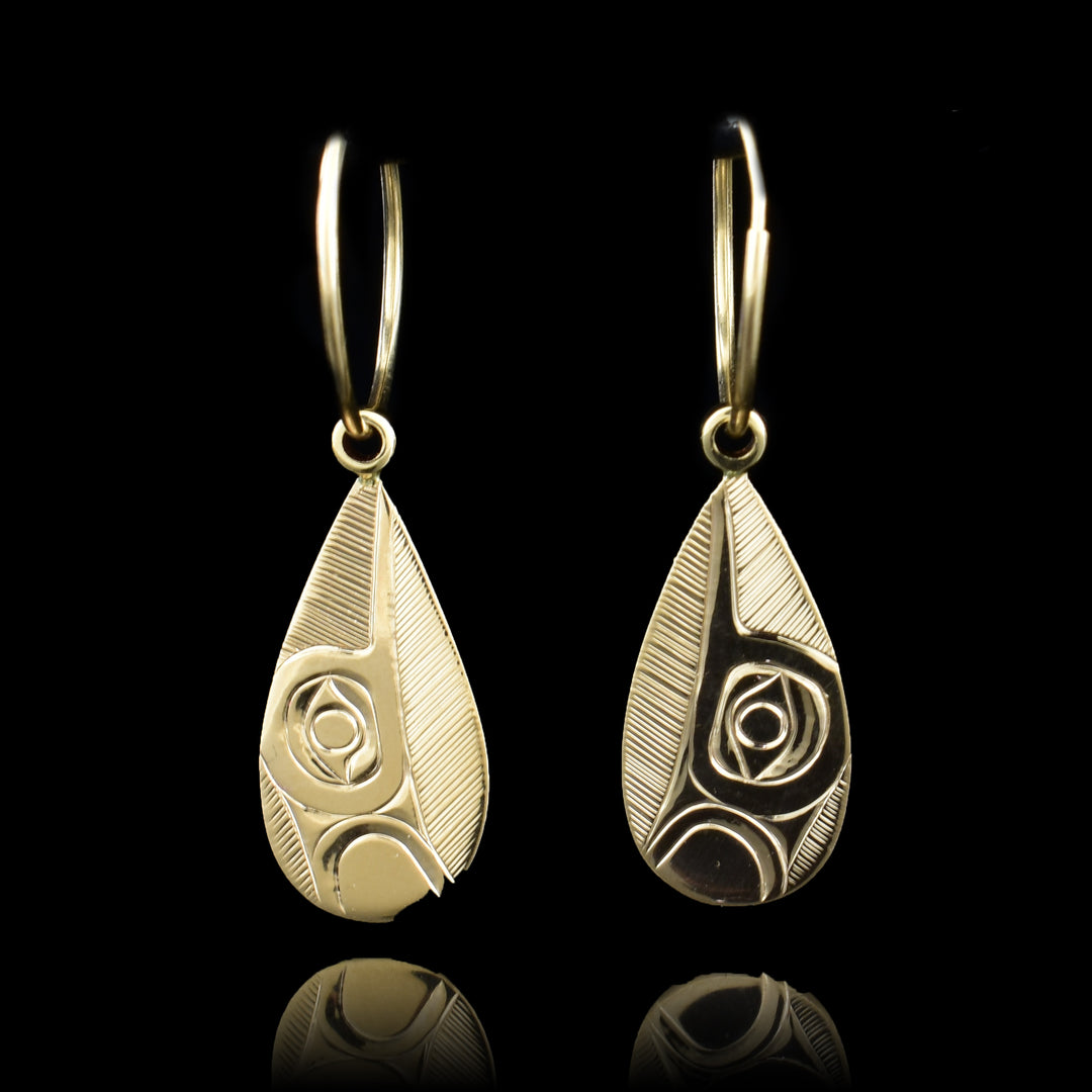 These dangling Hummingbird earrings are made from solid 14K gold and have teardrop shaped hangs. There are depictions of the Hummingbird at a side profile with their beaks facing upwards carved into the surface of the hangs.