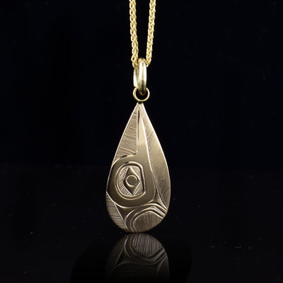 This 14K gold Hummingbird pendant has a teardrop shape and is made of solid gold. There is a depiction of the Hummingbird carved into the surface of the piece depicting the side profile of the legend.