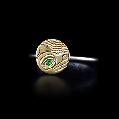 This gold ring has a sterling silver band with a 14K gold circle signet. On the signet is a depiction of the Bear carved into its surface and there is a tsavorite gemstone embedded in the eye of the Bear.
