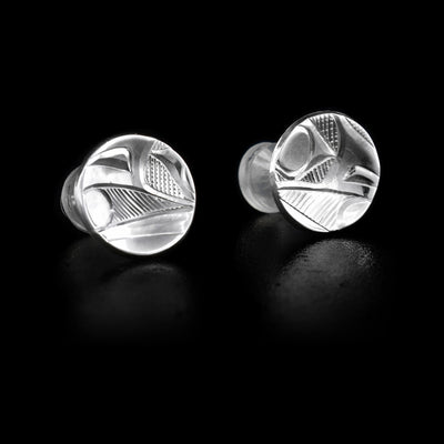 These circle, silver stud earrings have a depiction of the Raven carved into them.