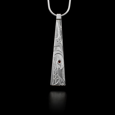 This sterling silver pendant is long, thin and is slightly wider at the bottom. A depiction of the Wolf is carved into it.