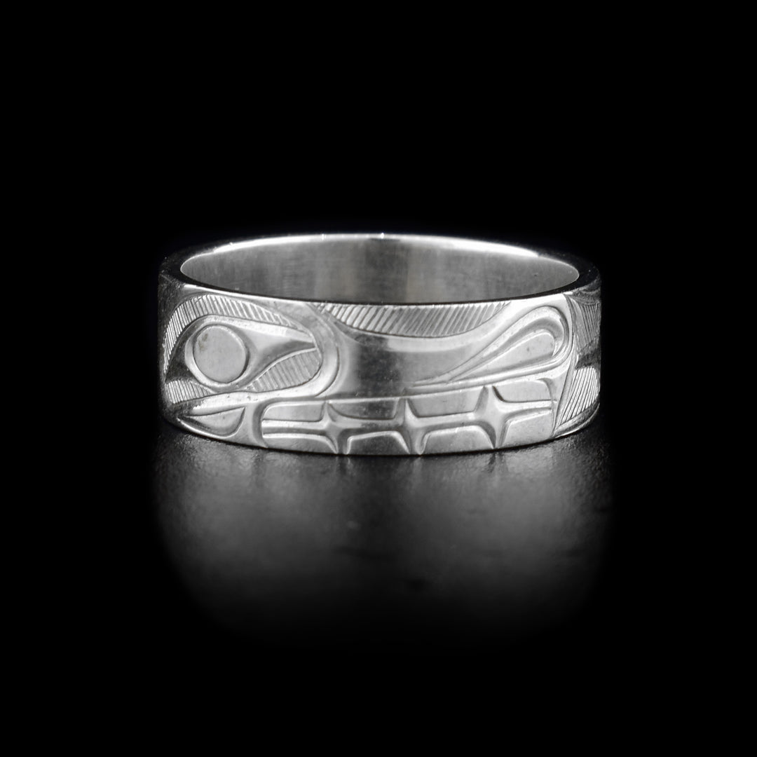 This sterling silver band ring is a single, flat band with a depiction of the Wolf that has been beautifully carved into the surface of it.