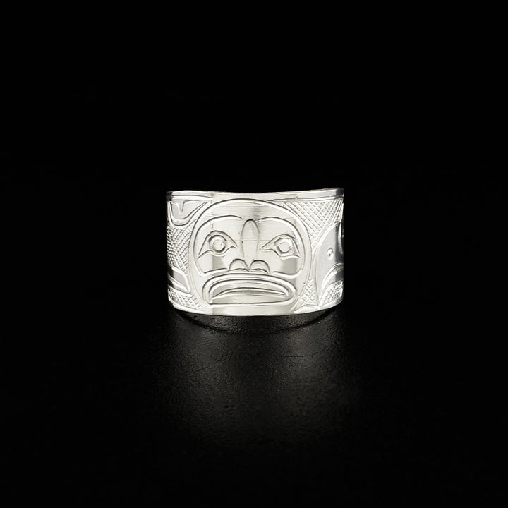 Front view of ring with moon. Moon is done in lines and ovoids. Background is cross-hatching.