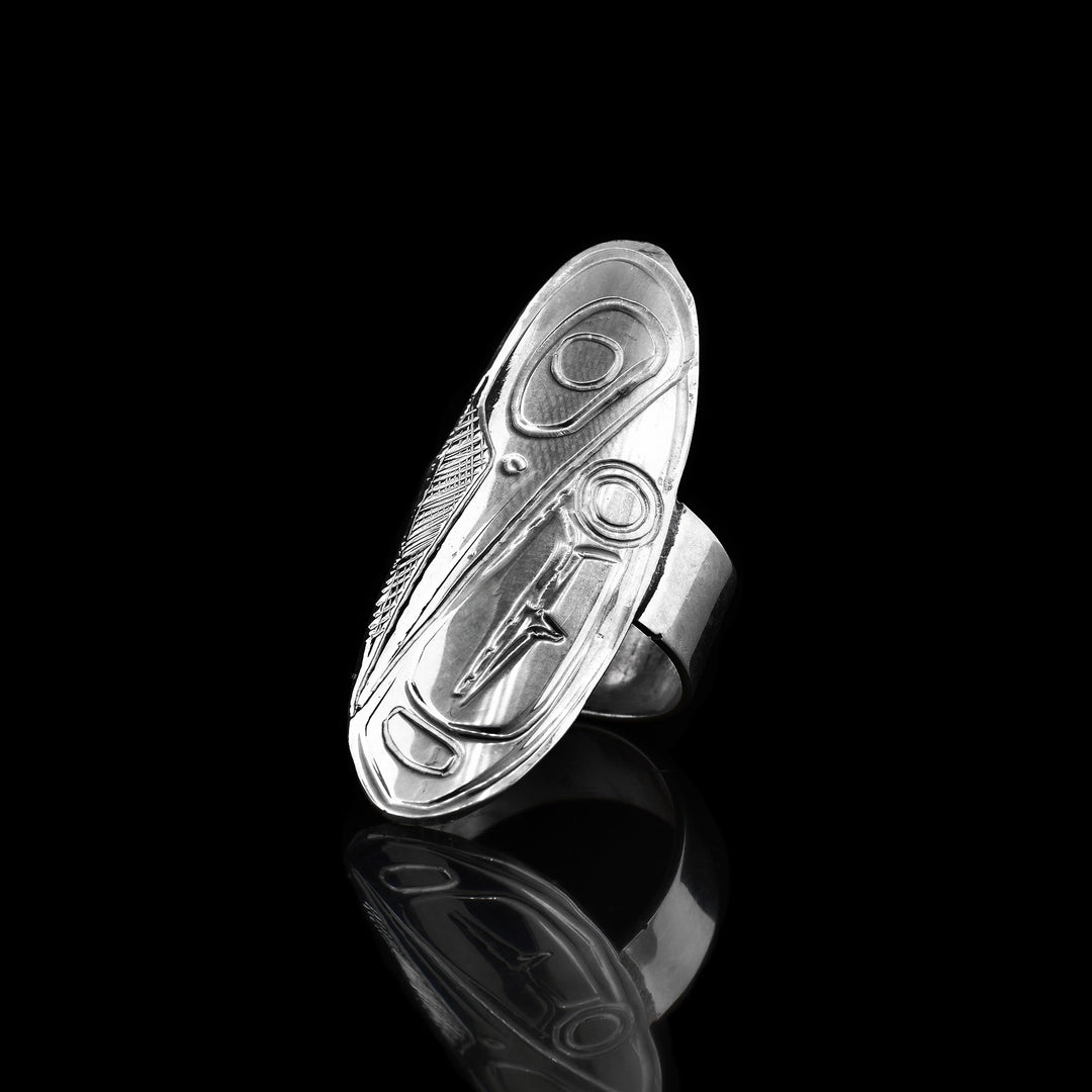 This sterling silver Hummingbird ring has a large oval shield that extends along the finger. Carved into the shield is a depiction of the Hummingbird.