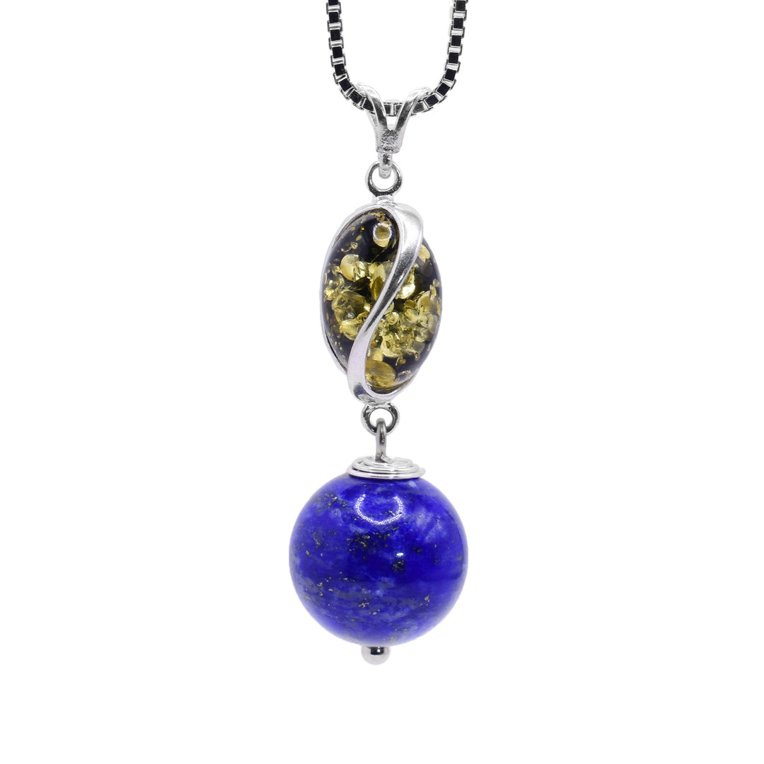 This lapis lazuli pendant has a sterling silver charm with deep, spiral ridges in it. In these ridges, there are amber pieces. Below the dangling charm, there is a large, sphere shaped lapis bead and the piece is held together using sterling silver.