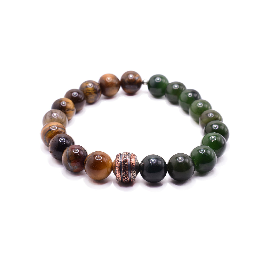 This copper charm bracelet has orange tiger's eye beads on one side and BC jade beads on the other side. The beads are small and sphere shaped. There is a copper bead in the center with a design on it. The designs has three, textured bands .