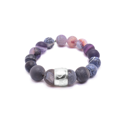 This beaded agate bracelet is made up of multi colored agate beads. The beads a sphere shaped, small and there is a sterling silver spirit bead in the front of it. There is a depiction of the Hummingbird carved into the spirit bead.