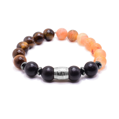 This Moon charm bracelet has black agate, orange agate and tiger's eye sphere shaped beads. Half is tiger's eye, the other half is orange agate and a small portion in the front is black agate. In the center of the black agate is a small spirit bead with a depiction of the moon carved into it. The Moon charm is made from sterling silver.
