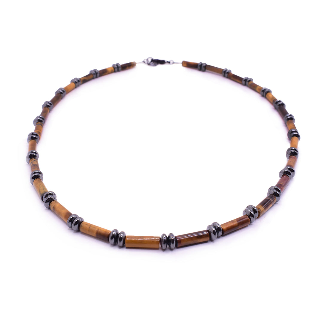 This tigers eye necklace has long, rectangular beads made of tigers eye. The tigers eye is colored orange and brown. There are two small, hematite gems separating the larger gemstone beads.