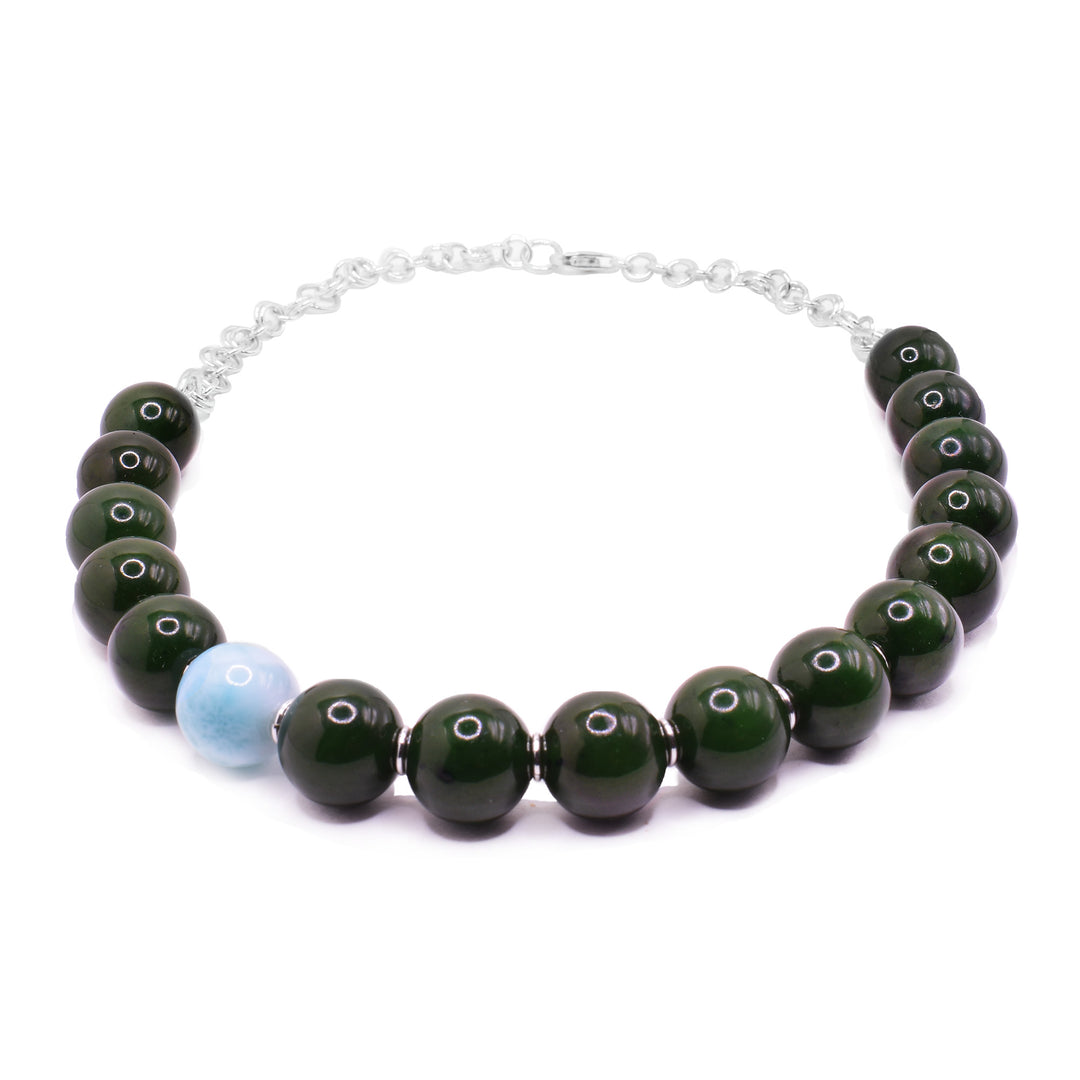 This gemstone bead necklace has a sterling silver chain and half of the piece has large, sphere shaped jade beads with a single, blue larimar highlight bead.