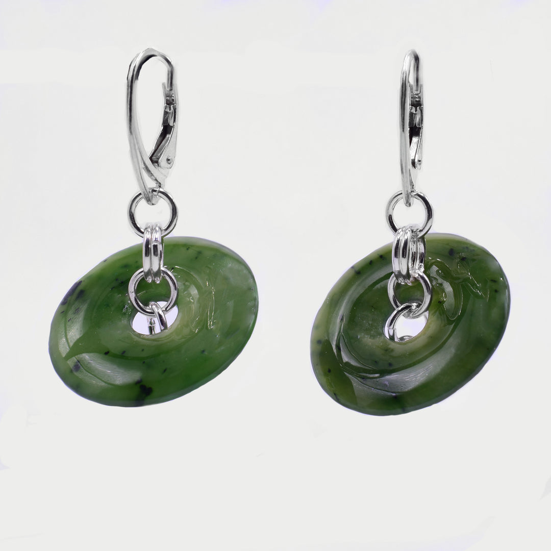 Oval jade disc earrings dangle from sterling silver leverback findings, connected by a small two-link chain.