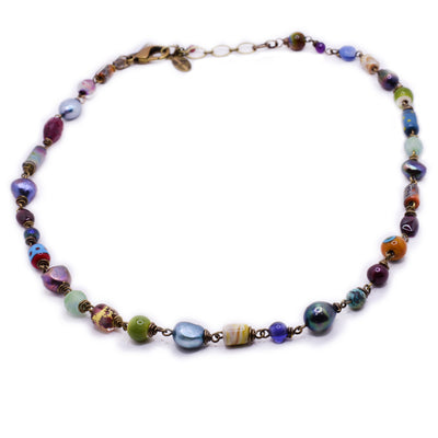 Station-style necklace with a plethora of beads in handmade lampworked glass, ruby, pearl and glass. By Wendy Pierson.