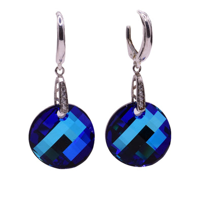 These Swarovski crystal earrings feature round bermuda blue Swarovski crystals with sterling silver leverback clips that incorporate cubic zirconia.