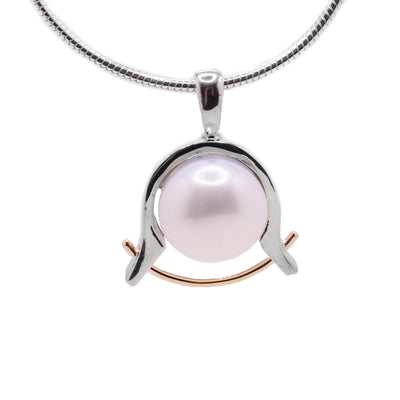 This silver pendant has a sterling silver band holding a fresh water pearl with a rose gold wire underneath it.