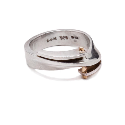 This gold and silver ring three layers at the top of the ring with 14K gold embellishments on them.