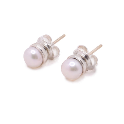 These sterling silver stud earrings have pearls attached into the prong.