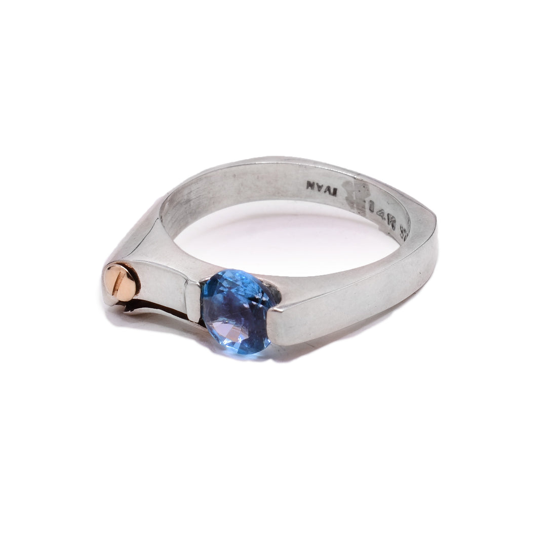 These dainty signet topaz rings are made from sterling silver. There is a 14K gold stud and a blue topaz gemstone on the signet of the ring.