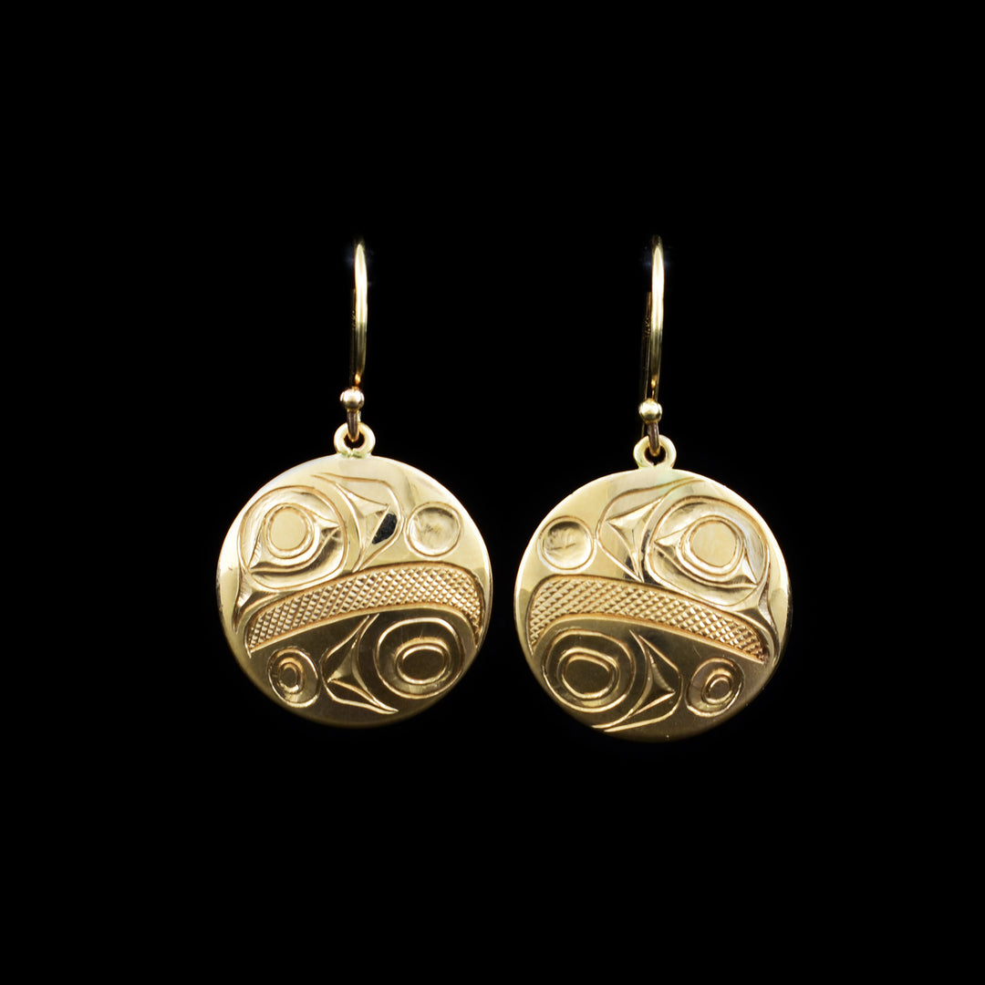 These Eagle earrings are made from 14K gold and have circle shaped hangs. There are chunky carvings on the surface of the hangs that depict the Eagle.