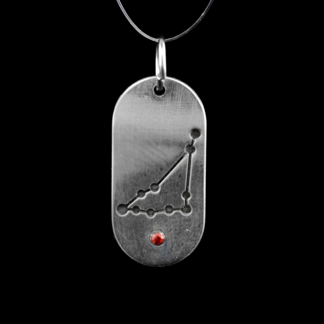 This January zodiac pendant features the January constellation of Capricorn. Underneath is a red cubic zirconia.