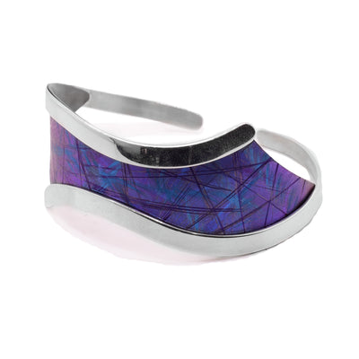 This titanium bracelet is wide and wavy at the top of the cuff and there is blue, anodized titanium there. The rest of the cuff bracelet is made form a thin band.