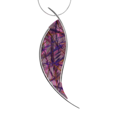 This titanium necklace has an abstract, teardrop shaped pendant made from titanium. The pendant has colorful pink and purple designs on it achieved by anodizing the metal. The pendant is held between two thin sterling silver wires.