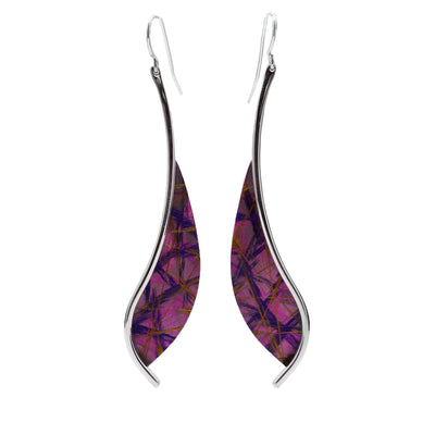 These titanium earrings have long, sterling silver wires with teardrop shaped titanium pieces. The titanium has pink and blue designs on it that are achieved by anodizing the metal.