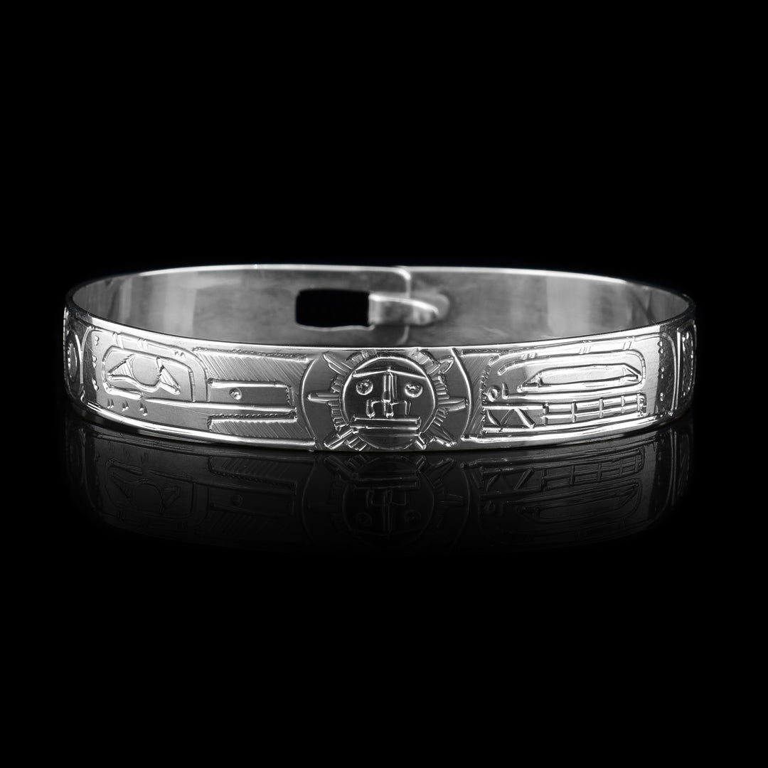 This Hummingbird, Orca and Sun bracelet has a single, sterling silver band with a clasp in the back. There is a depiction of the Sun in the center of the band positioned between the Hummingbird and the Orca. The legends are beautifully carved into the surface of the band.