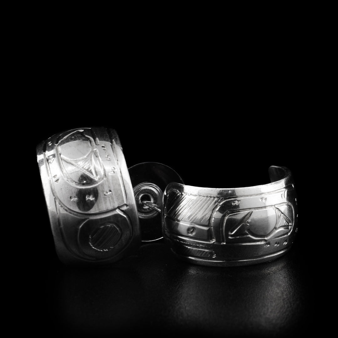 These wide hoop earrings are made out of a flat piece of sterling silver. It has the face of the Hummingbird engraved on it. The earrings measure 1/2" in width and 3/4" in length.