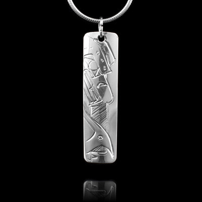This sterling silver pendant is a small rectangle. There is a depiction of the Eagle and a depiction of the Orca carved onto to either side of this double sided, carved pendant.