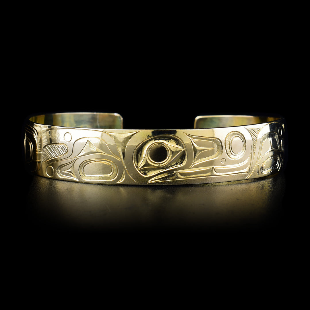 This 14K gold Orca bracelet has a depiction of the Orca carved into the surface of the band.