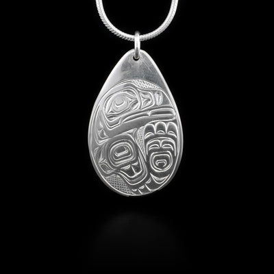 This sterling silver pendant is tear drop shaped and has a depiction of the Raven carved into it.