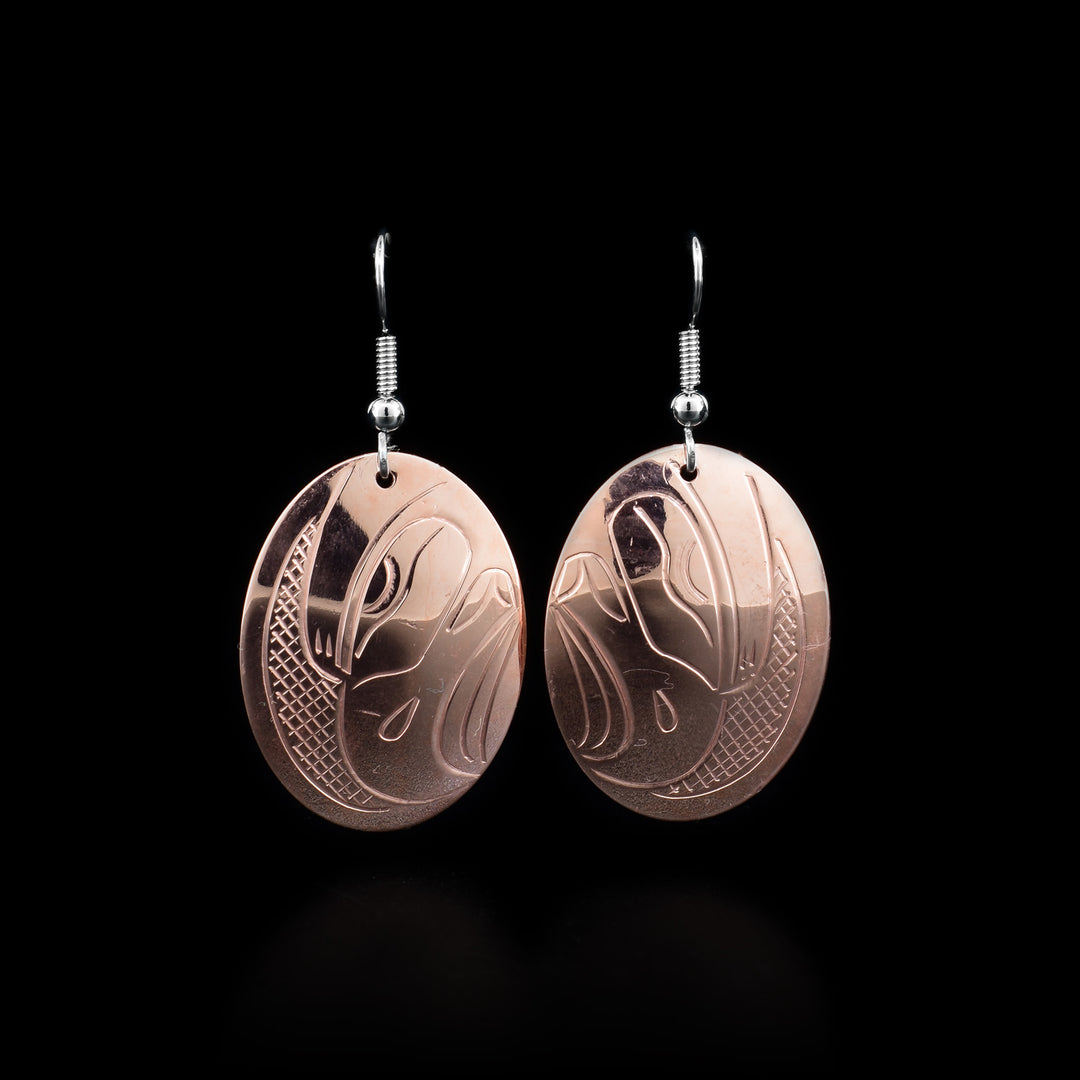 These Eagle earrings are made from copper and have oval shaped hangs. There are depictions of the Eagle carved into the surface of the hangs.