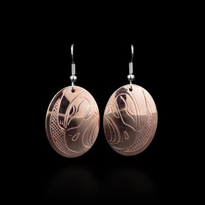 These Eagle earrings are made from copper and have oval shaped hangs. There are depictions of the Eagle carved into the surface of the hangs.