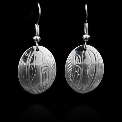 These sterling silver earrings have hooks that have oval hangs. The hangs depict the face ofthe Orca.