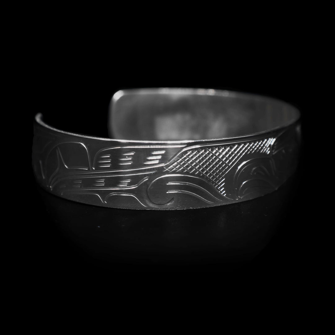 Left angle photo of the eagle cuff bracelet features the legend's feathers.