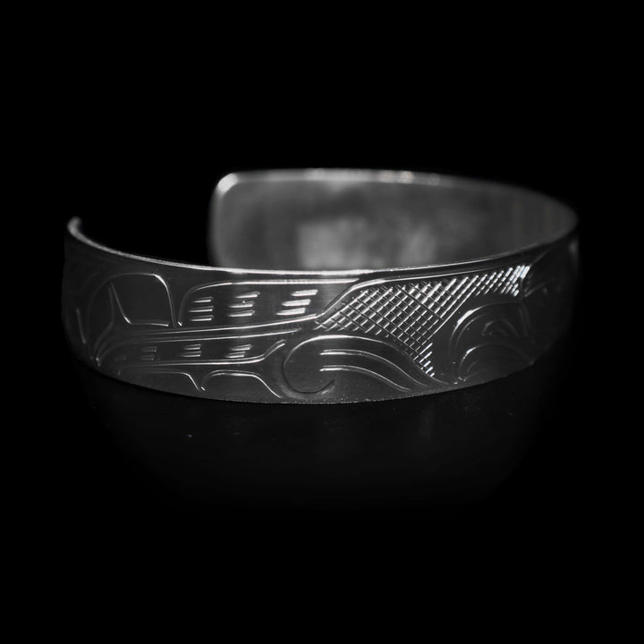 Left angle photo of the eagle cuff bracelet features the legend's feathers.