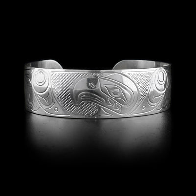 This sterling silver cuff bracelet has a wide band with a depiction of the Eagle carved into it.