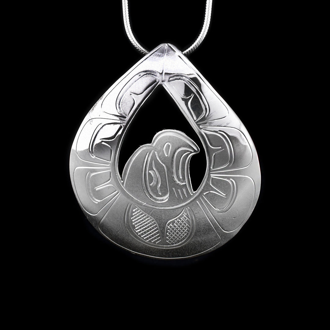 This sterling silver Eagle pendant is teardrop shaped with a cut out in the middle around the head of the Eagle. There are carvings that depict the Eagle on the pendant.