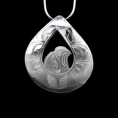 This sterling silver pendant is teardrop shaped with a cut out in the middle around the head of the Eagle. There are carvings that depict the Eagle on the pendant.