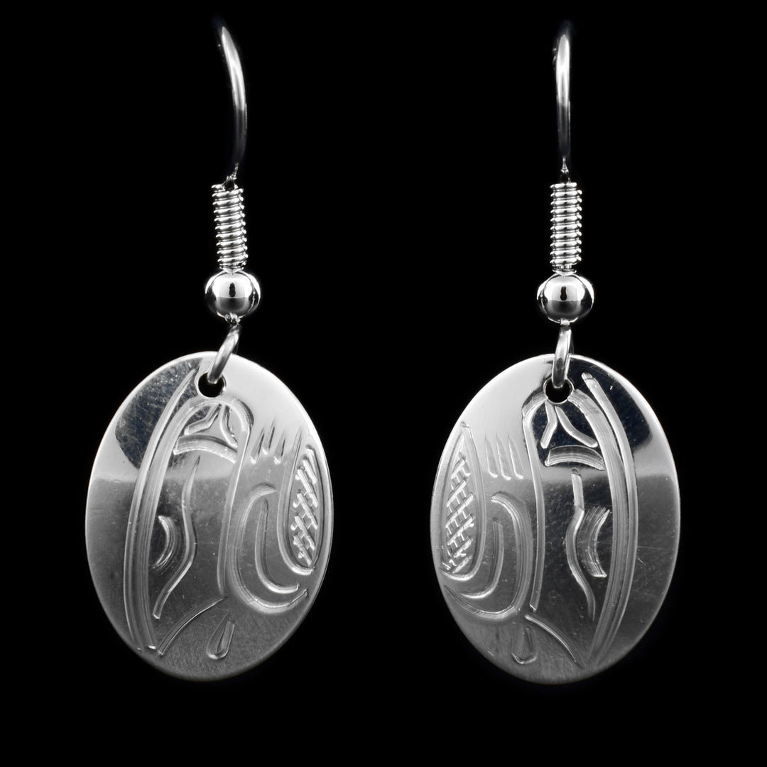 These sterling silver dangle earrings have oval hangs with depictions of the Eagle carved into them.