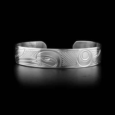 This sterling silver cuff bracelet has a depiction of the Hummingbird carved into it.