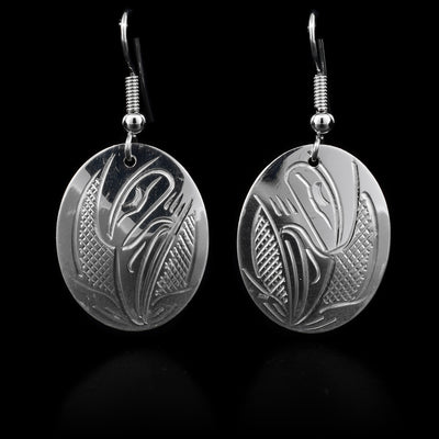 These sterling silver dangle earrings have oval shaped hangs with Hummingbirds carved into them.