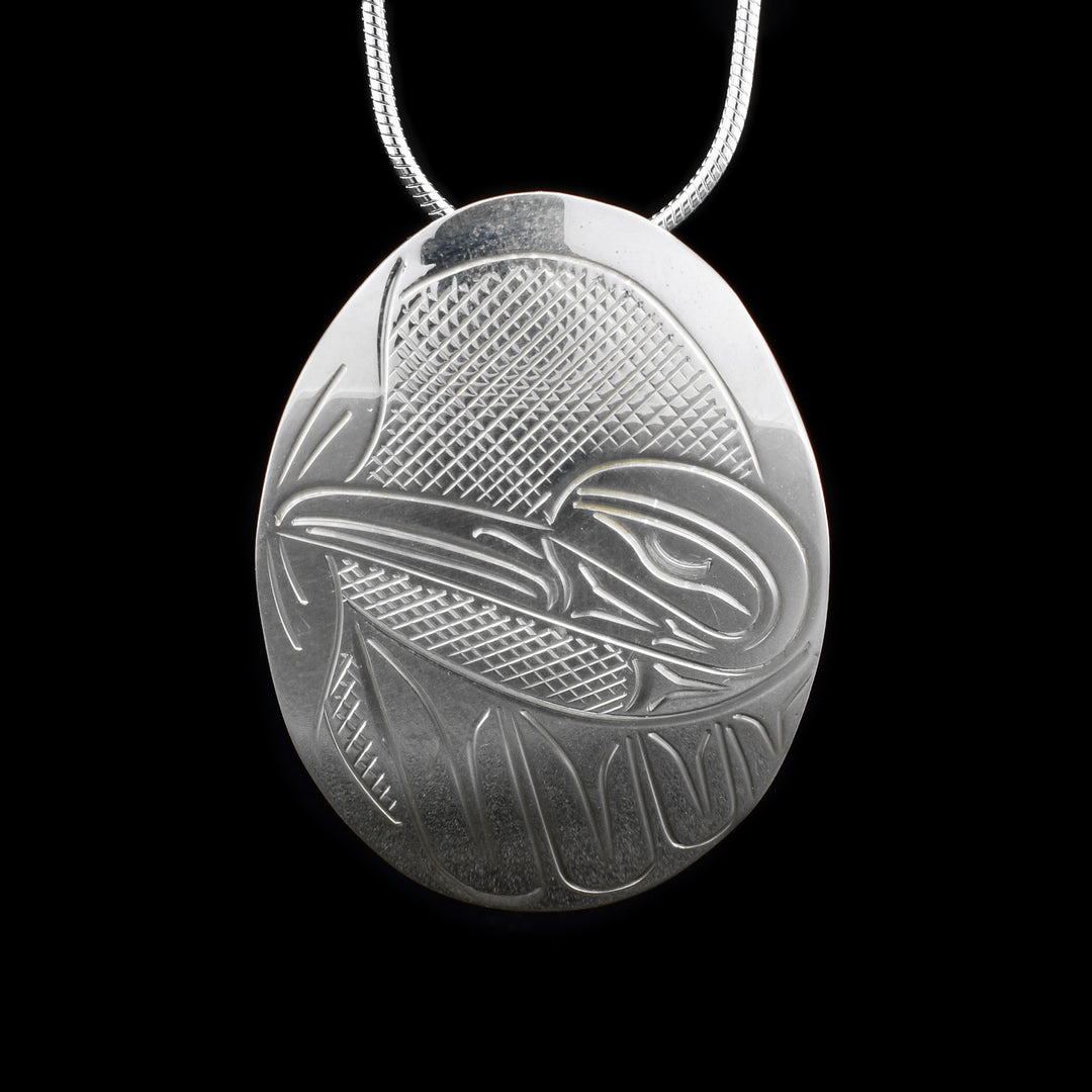 This sterling silver Hummingbird pendant is oval shaped and has a depiction of the Hummingbird craved into it.