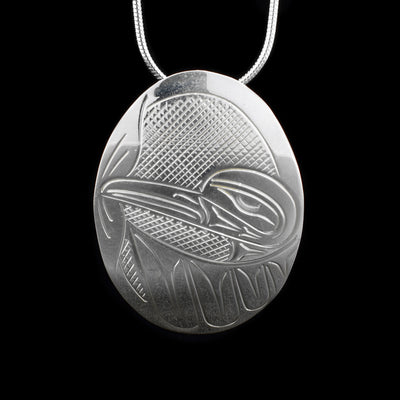 This stelring silver pendant is oval shaped and has a depiction of the Hummingbird craved into it.
